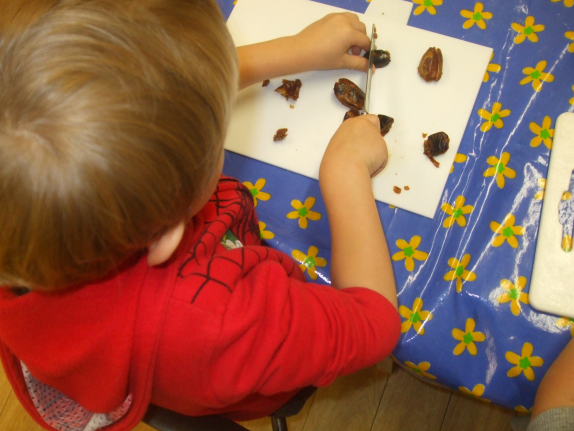 Picture of child chopping dates